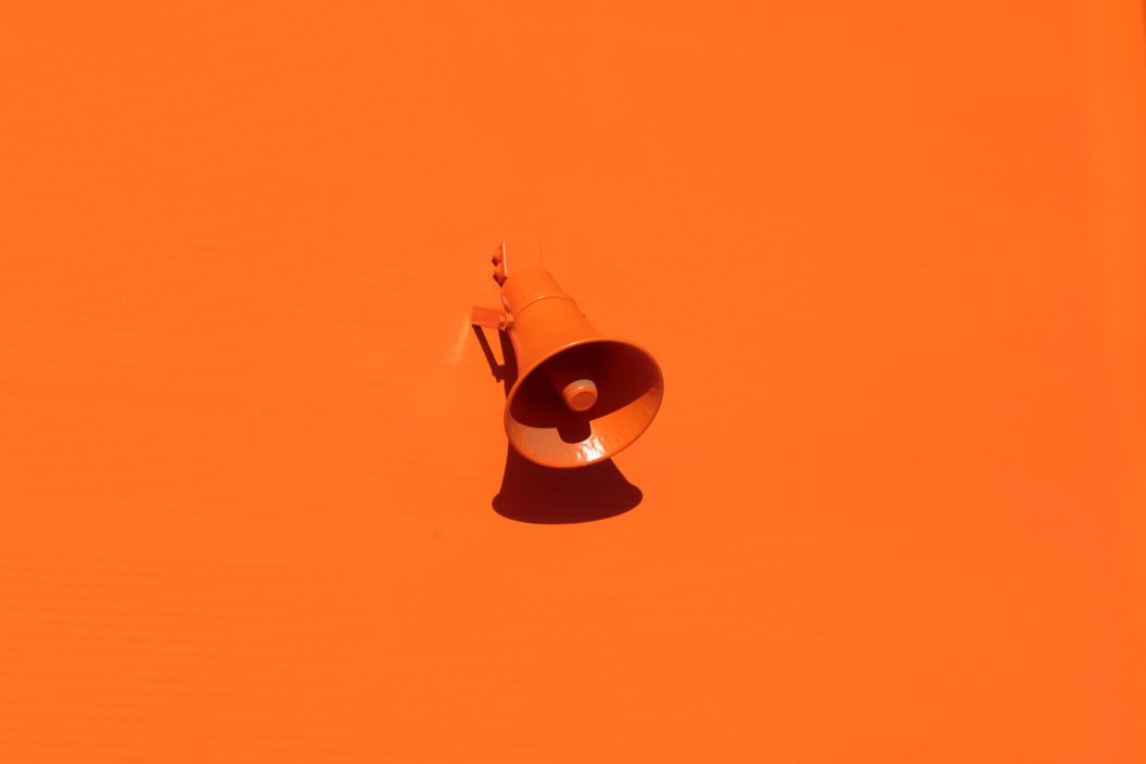 orange megaphone on an orange background