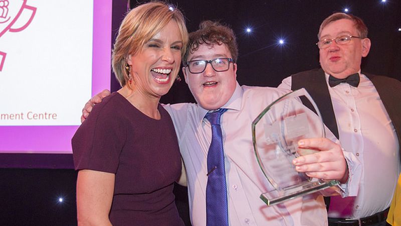 Scottish Commission for Learning Disability - Rhona dougall with an award finalist who is holding a trophy