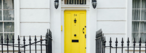 A white house with a yellow door
