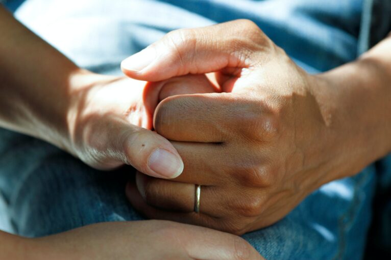 Hands clasped together in support